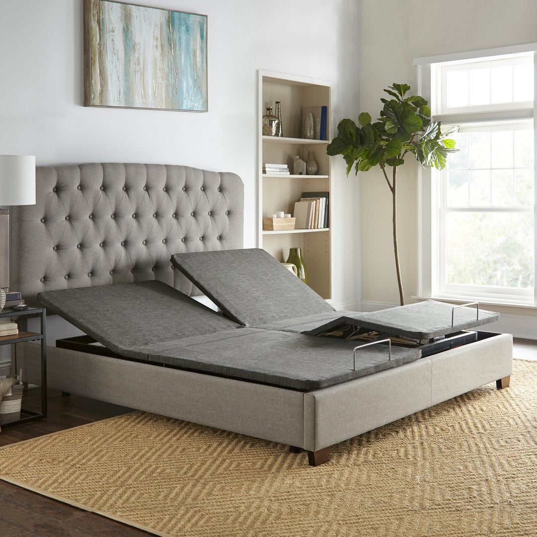 split king size adjustable power base with head and foot raised inside a platform bed frame in a simple bedroom setting
