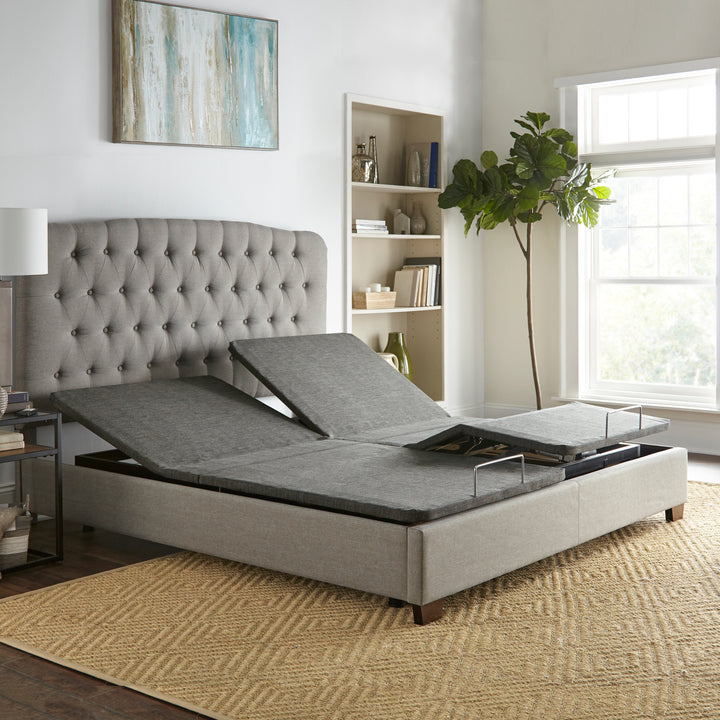 split king size adjustable power base with head and foot raised inside a platform bed frame in a simple bedroom setting