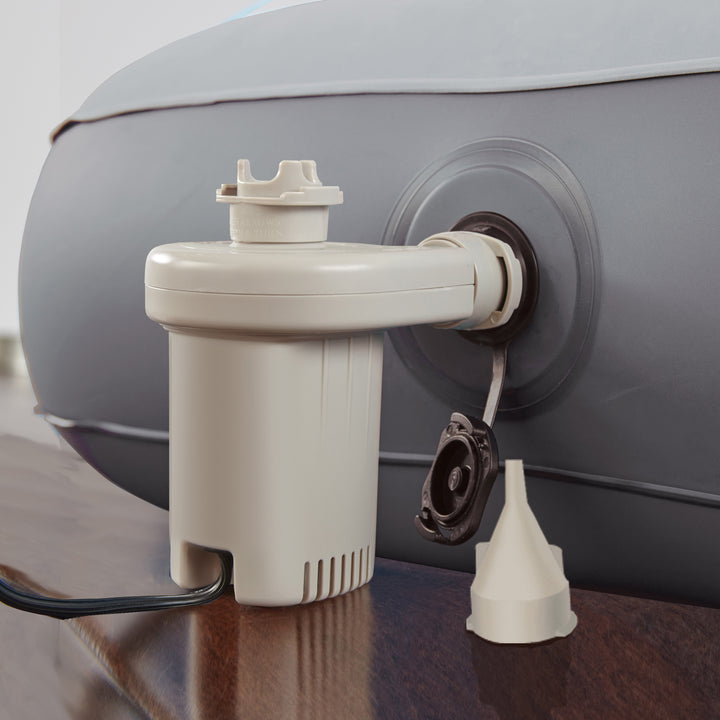 White pump attached to a large gray cylindrical tank on a reflective surface.