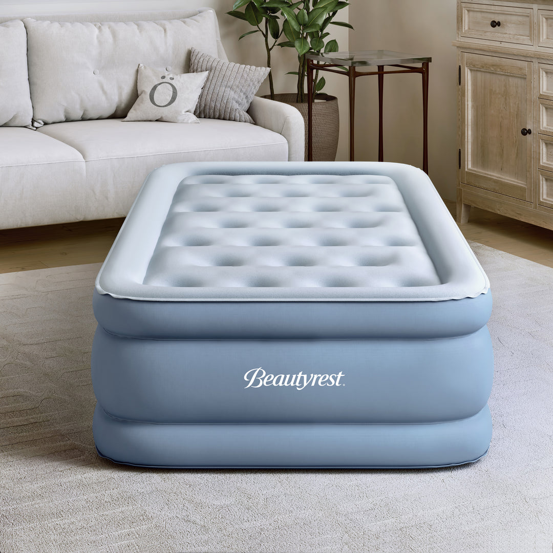 Inflatable mattress with Beautyrest branding in a living room setting.